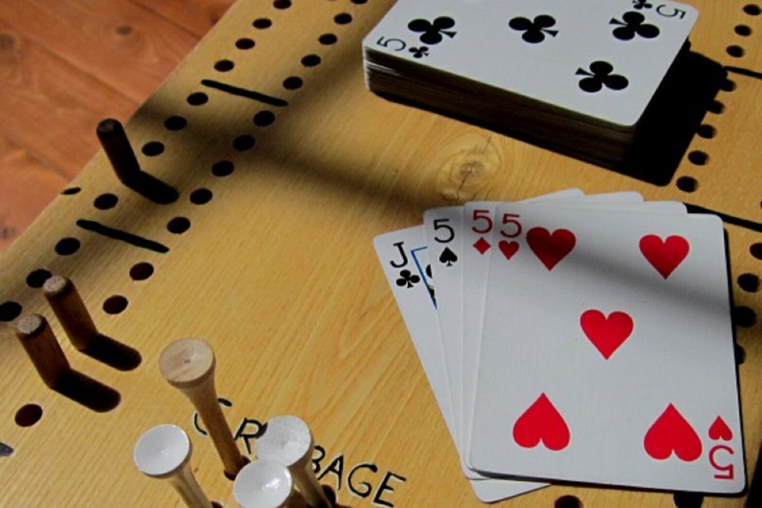 close up of a cribbage board and playing cards