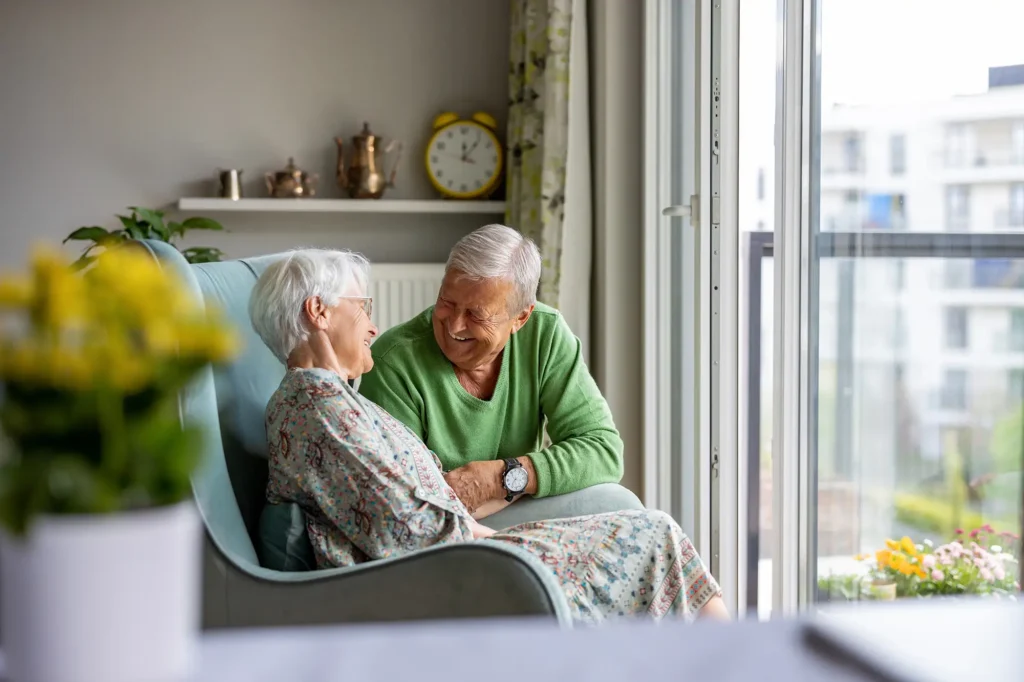 couple in assisted living looking out the window