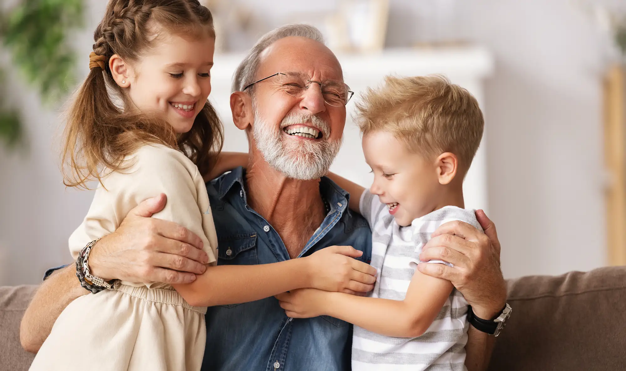 senior man hugging his grandkids