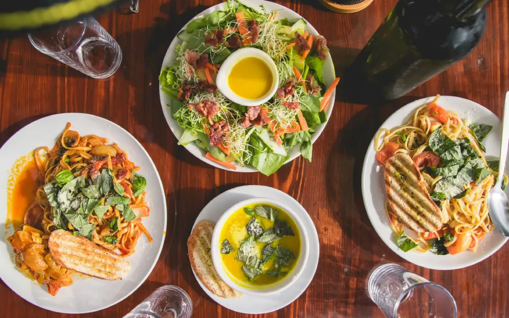 an array of lunch meals, including salad, soup, and pastas