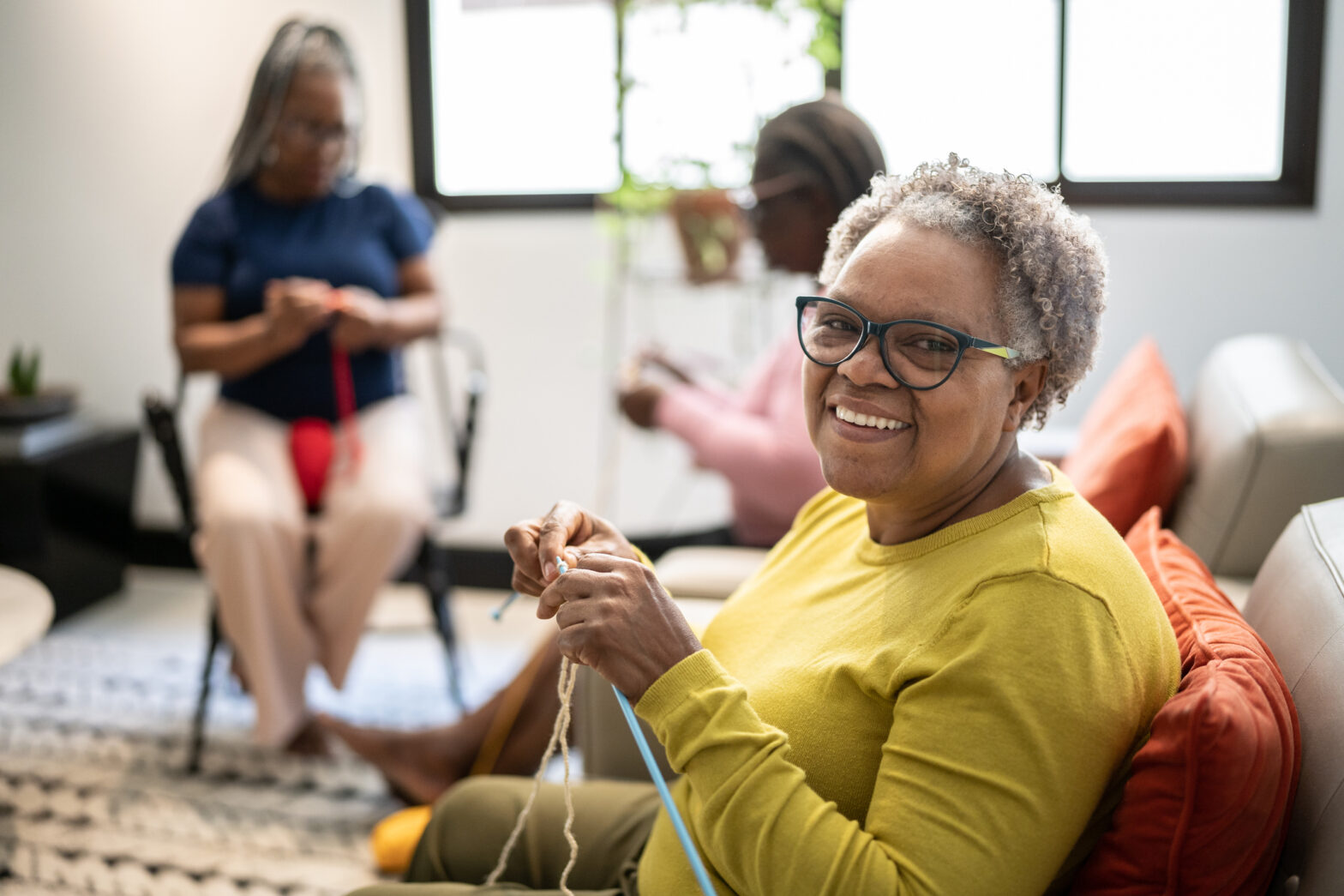 Portrait of a senior woman knitting as part of creative and social activities for assisted living at The Delaney at The Vale.