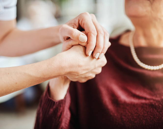 woman holding hands with elderly woman