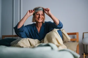 How much sleep do seniors need to wake up happy like this youngish senior woman